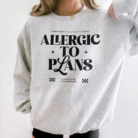 Woman wearing the Allergic to Plans ash grey sweatshirt with black leggings — casual, relaxed outfit for homebodies.
