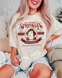 Woman wearing Aunt Bethany Sprinkles Christmas Vacation heavyweight tee in ivory