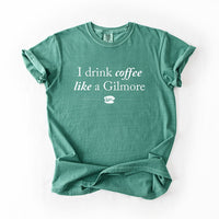I Drink Coffee Like A Gilmore tee flat lay in light green, heavyweight unisex Gilmore Girls inspired graphic t-shirt