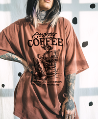 Model wearing Cowboy Coffee tee in yam — bold western graphic t-shirt with vintage coffee design