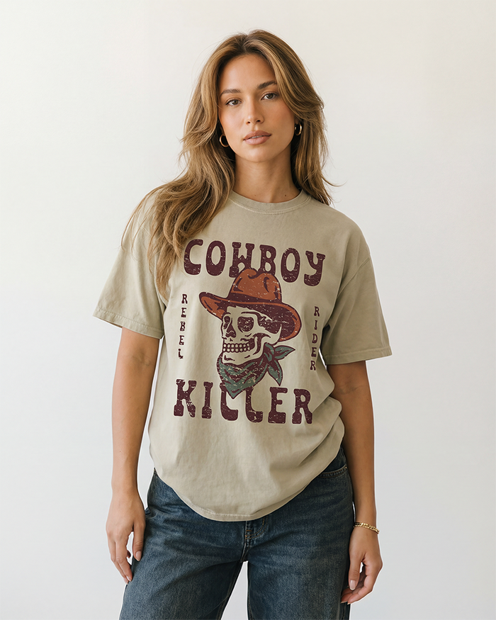 Woman wearing a Sandstone Cowboy Killer Western skull graphic tee with relaxed fit and blue jeans.