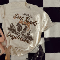 Flat lay of ivory Dirt Roads and Daydreams tee — soft oversized country t-shirt with multicolor print