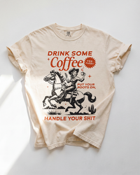 Ivory Drink Some Coffee Western heavyweight tee with vintage cowgirl, horse and coffee graphic in rust and black.