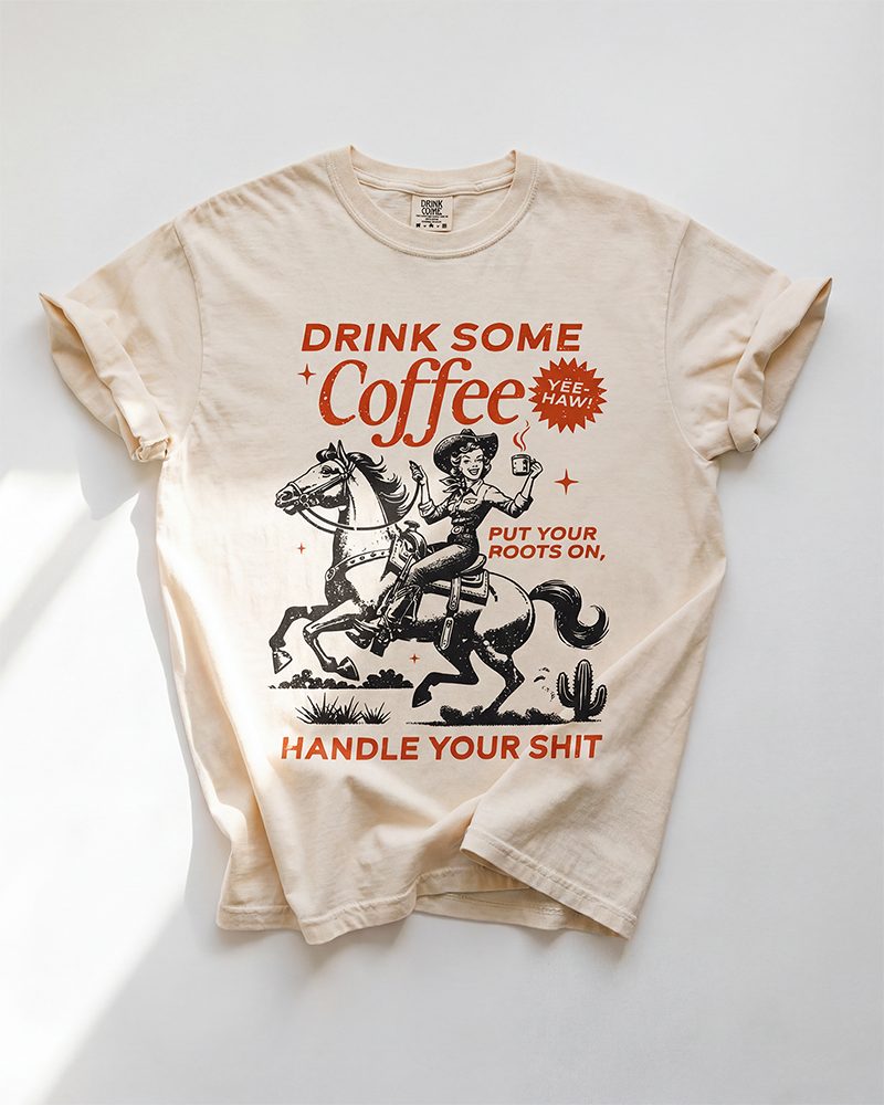 Ivory Drink Some Coffee Western heavyweight tee with vintage cowgirl, horse and coffee graphic in rust and black.