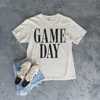 Ivory Game Day Comfort Colors tee styled with denim cutoff shorts and sneakers — sporty boutique outfit for football, baseball, basketball, or soccer fans.