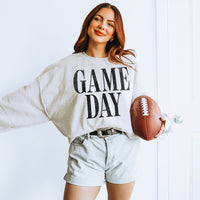 Woman wearing Ash Game Day sweatshirt — cozy unisex fleece crewneck for football season and fall weekends.