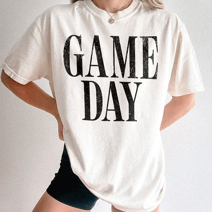 Oversized ivory Game Day Comfort Colors tee styled with biker shorts — relaxed boutique look for sports fans and cozy weekends.