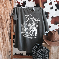 Flat lay of Going Nowhere tee in pepper — rustic cowboy-inspired shirt with bold white text
