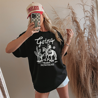 Model wearing Going Nowhere tee in black — cowboy graphic t-shirt for women