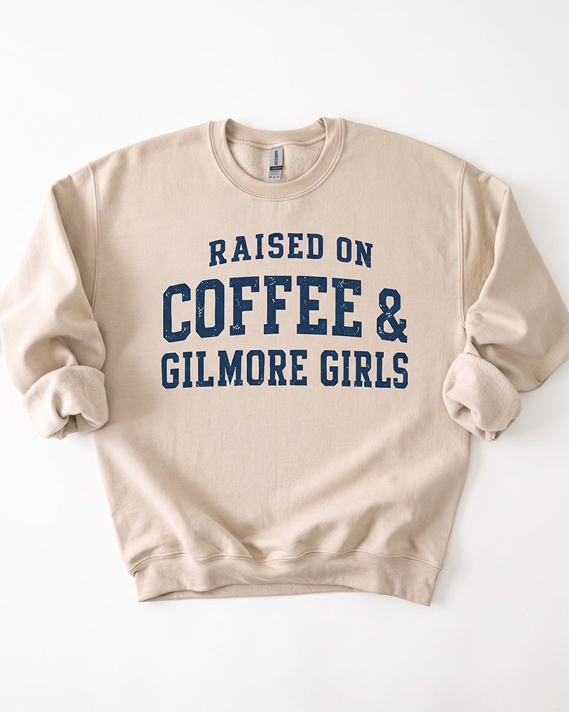 Sand Raised On Coffee & Gilmore Girls crewneck sweatshirt with distressed navy blue collegiate graphic lettering.