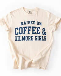 Ivory Raised On Coffee & Gilmore Girls Comfort Colors heavyweight tee with distressed navy collegiate graphic.