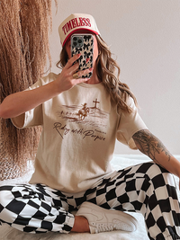 Selfie view of Proverbs 19:21 shirt — relaxed fit Christian graphic tee with brown print