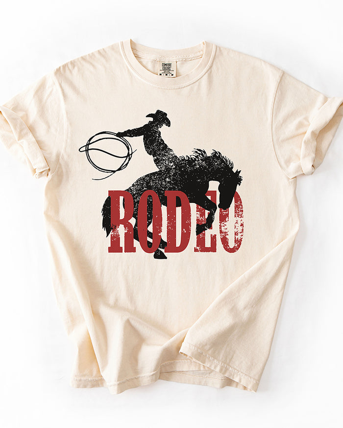 Ivory Rodeo Western heavyweight tee with distressed black cowboy and bucking horse graphic over red lettering.