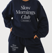 Model wearing navy Slow Mornings Club sweatpants styled with matching crewneck sweatshirt for a relaxed slow living outfit
