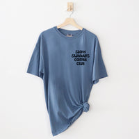 Flat lay of blue jean Slow Sundays Coffee Club tee — front graphic on vintage wash shirt