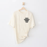 Flat lay of ivory tee front — slow living coffee shirt with hand-drawn snail design