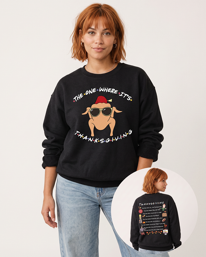 Red-haired woman wearing a black Friends Thanksgiving crewneck sweatshirt with light blue denim, featuring the turkey in sunglasses and illustrated back print.