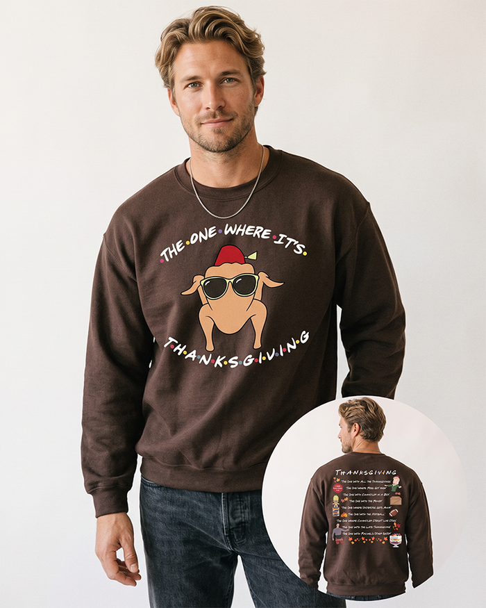 Blond male model wearing a dark chocolate Friends-inspired Thanksgiving crewneck sweatshirt with black denim jeans, showing the turkey front print and Thanksgiving episode back artwork.