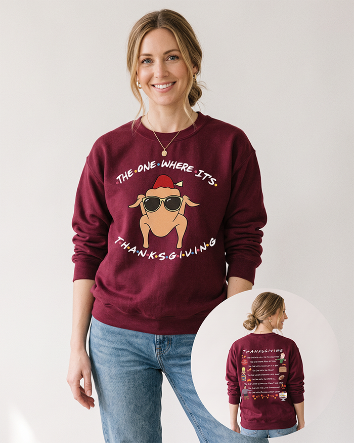 Blonde woman wearing a maroon The One Where It's Thanksgiving sweatshirt with blue jeans, featuring colorful Friends-inspired front and back graphics.