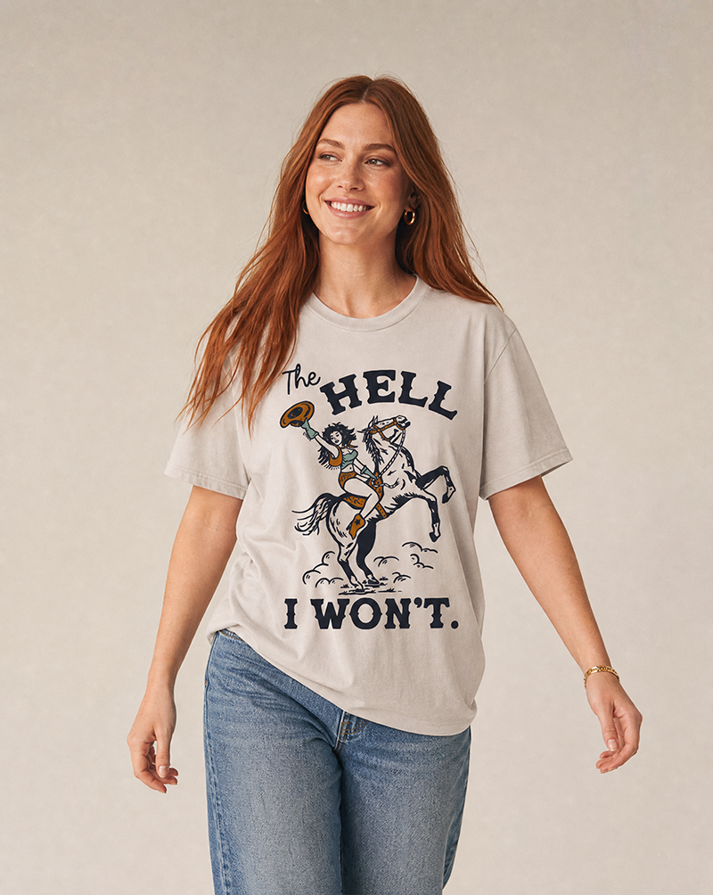 Woman wearing a lightweight Western graphic tee with The Hell I Won't cowgirl and horse artwork.