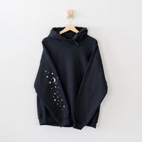 Flat lay of black hoodie sleeve — funny printed sleeve design for camping sweatshirt