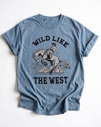 Blue Jean Wild Like The West heavyweight tee with black cowboy, bucking horse and desert Western graphic.