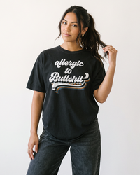 Woman wearing Allergic to Bullshit heavyweight graphic tee in washed black with retro distressed print