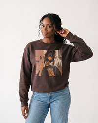 Woman wearing dark chocolate iced coffee graphic sweatshirt with jeans