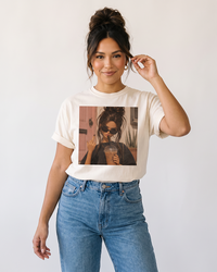Woman wearing ivory iced coffee and attitude graphic tee with jeans