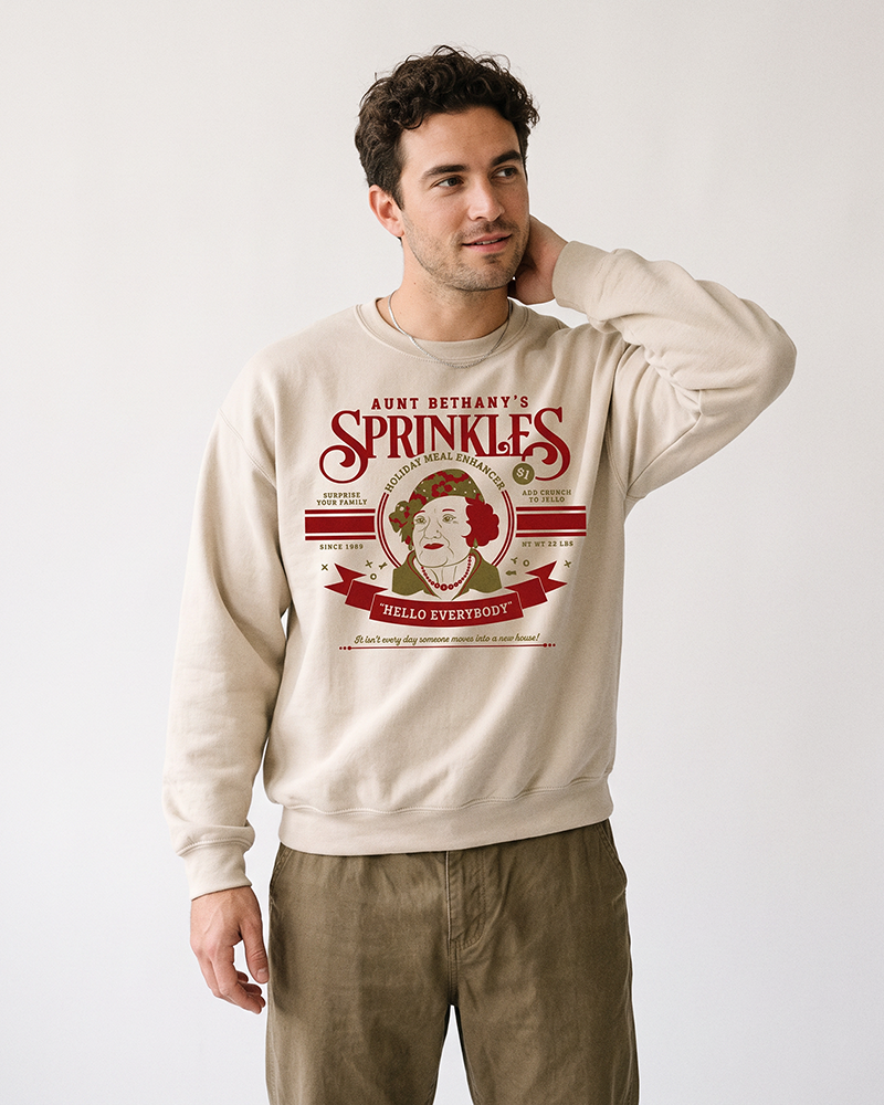 Man wearing sand Aunt Bethany Sprinkles Christmas Vacation crewneck sweatshirt