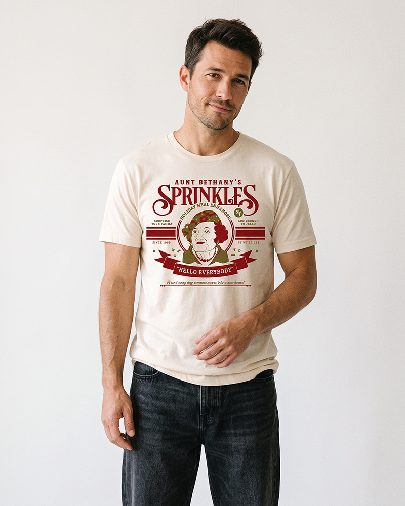 Man wearing natural Aunt Bethany Sprinkles lightweight Christmas graphic tee