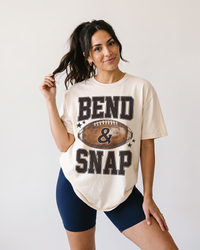 Woman wearing ivory Bend and Snap football heavyweight graphic tee