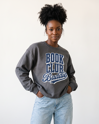 Woman wearing charcoal Book Club Baddie graphic sweatshirt