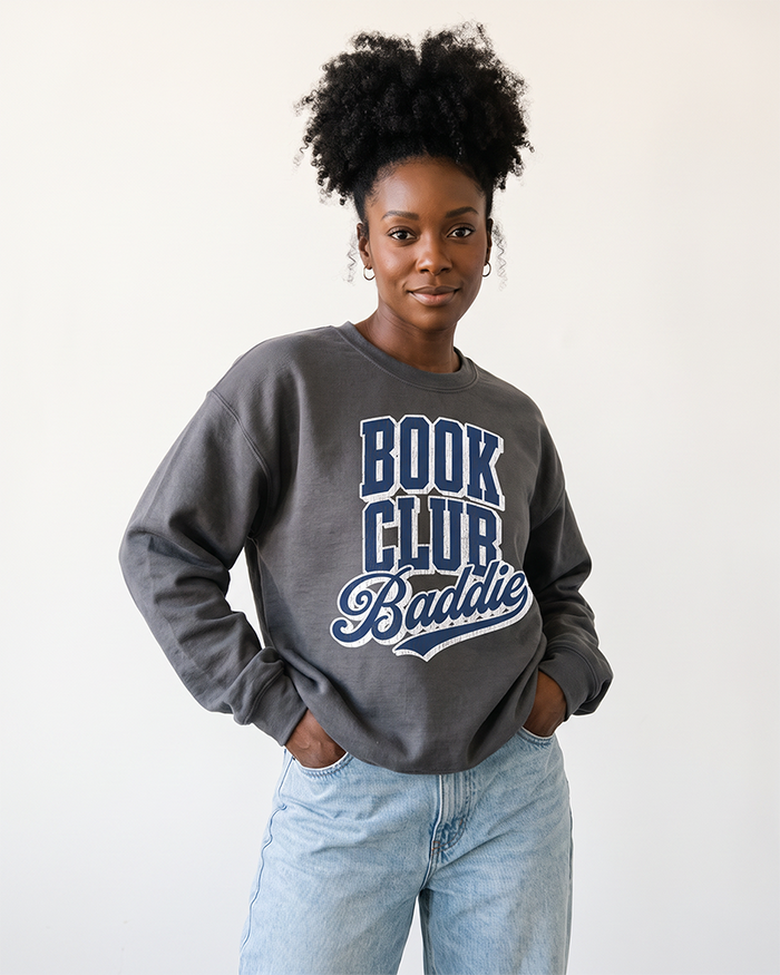 Woman wearing charcoal Book Club Baddie graphic sweatshirt