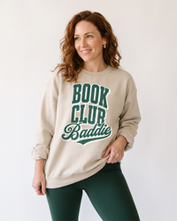 Woman wearing sand Book Club Baddie bookish crewneck sweatshirt