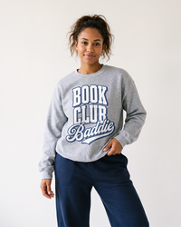 Woman wearing sport grey Book Club Baddie crewneck sweatshirt