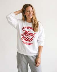 Woman wearing white Caffeinated Moms Club sweatshirt with gray lounge pants