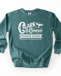 Blue Spruce green garment-dyed Christmas sweatshirt featuring a white vintage-style Clark & Company Premium Eggnog graphic.