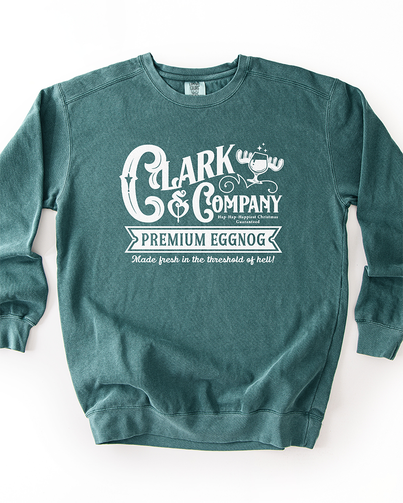 Blue Spruce green garment-dyed Christmas sweatshirt featuring a white vintage-style Clark & Company Premium Eggnog graphic.
