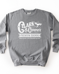 Grey Comfort Colors heavyweight crewneck sweatshirt with white Clark & Company Premium Eggnog Christmas graphic.