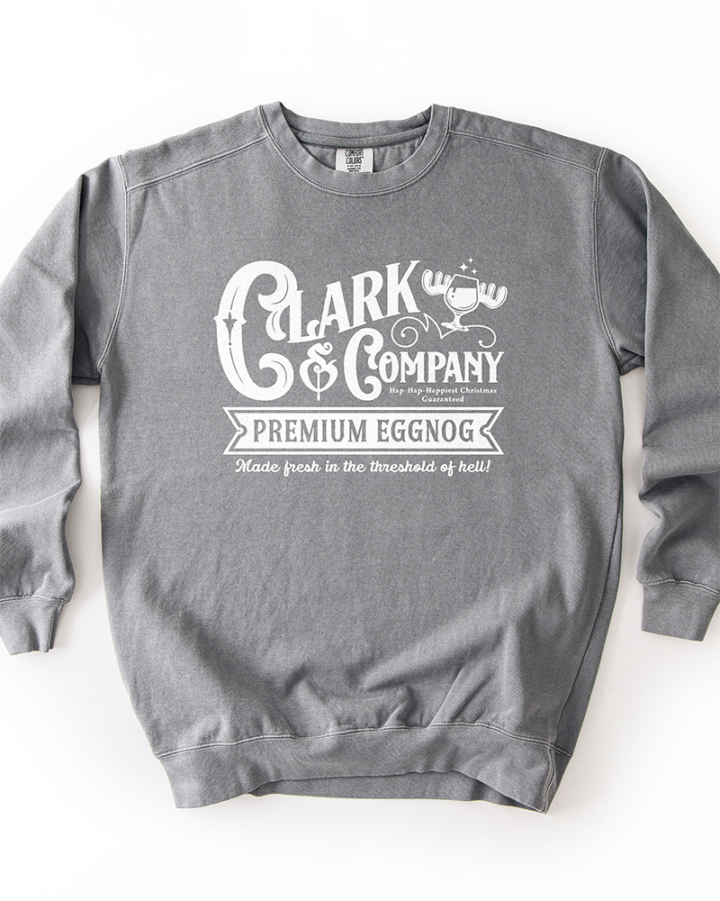 Grey Comfort Colors heavyweight crewneck sweatshirt with white Clark & Company Premium Eggnog Christmas graphic.