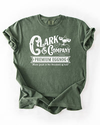 Hemp green Comfort Colors heavyweight tee with white vintage-style Clark & Company Premium Eggnog Christmas Vacation graphic.