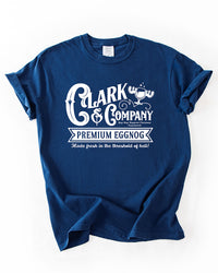 True Navy Comfort Colors heavyweight Christmas t-shirt featuring a white Clark & Company Premium Eggnog graphic.