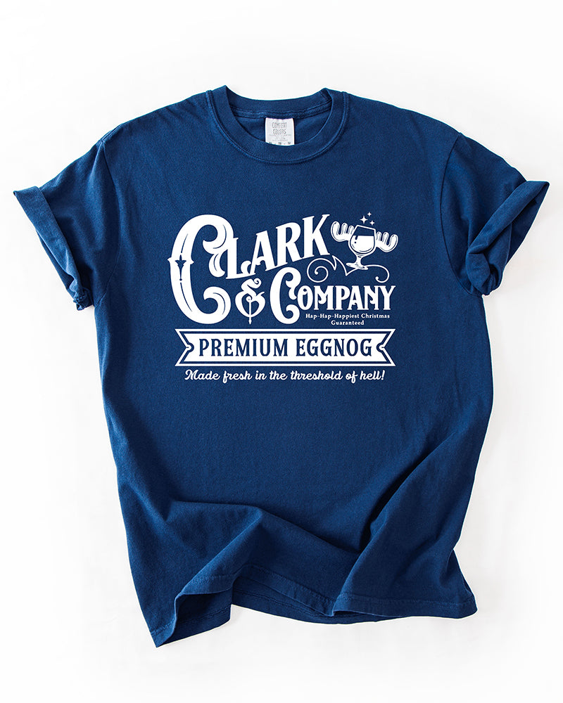 True Navy Comfort Colors heavyweight Christmas t-shirt featuring a white Clark & Company Premium Eggnog graphic.
