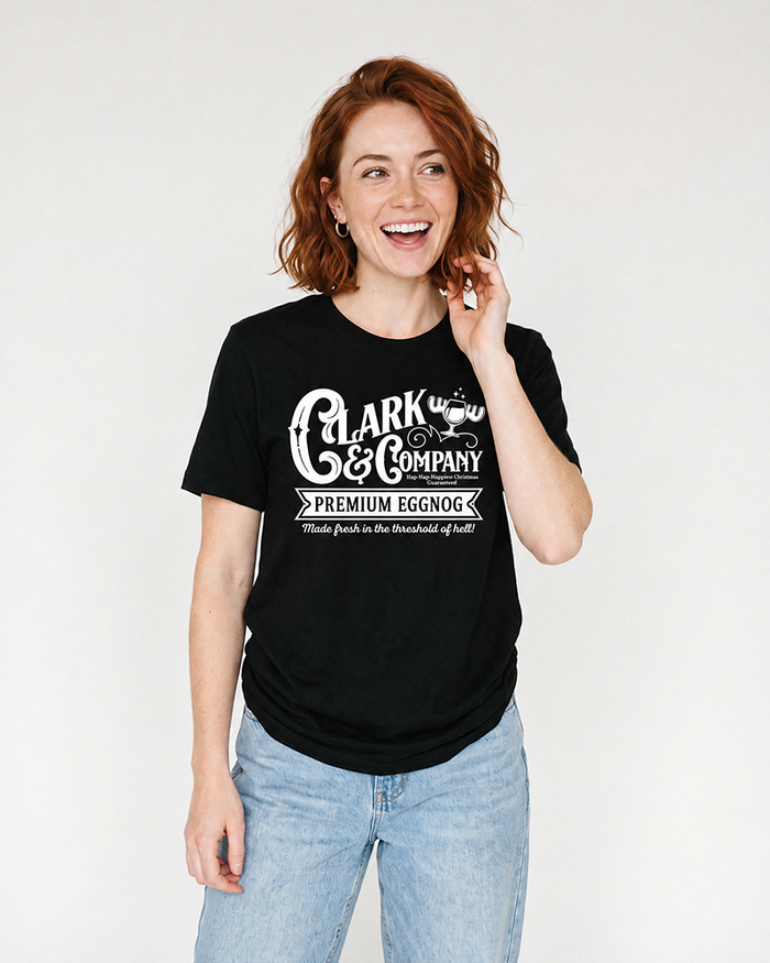 Woman modeling a black Clark Griswold-inspired eggnog Christmas graphic tee with blue jeans.