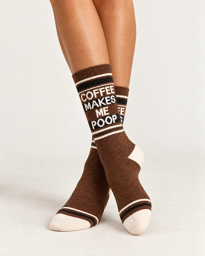 Female model wearing Coffee Makes Me Poop brown gym socks with retro cream and black accents