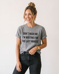 Woman wearing Grey funny procrastination graphic tee with Don't Rush Me quote