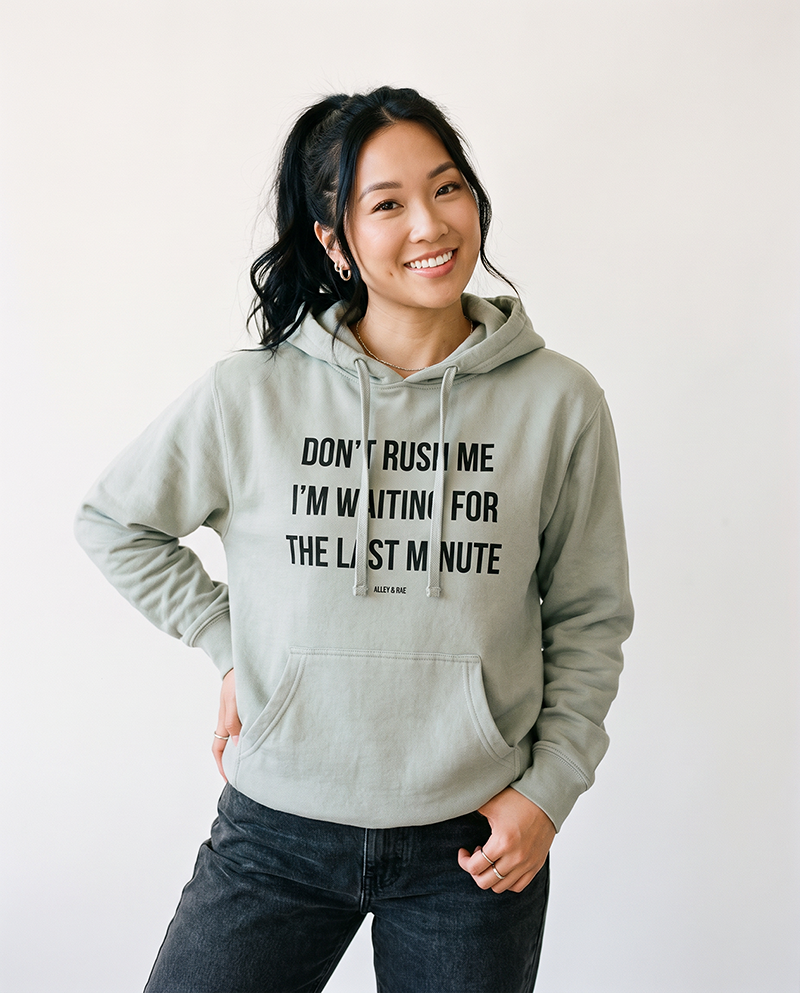 Woman wearing Dusty Sage Don't Rush Me I'm Waiting For The Last Minute hoodie