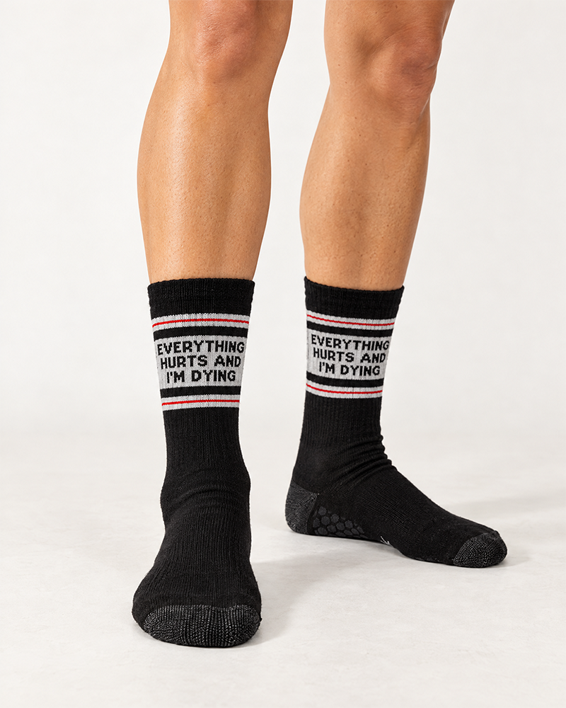 Female model wearing black Everything Hurts and I'm Dying crew grip socks for Pilates