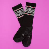 Everything Hurts and I'm Dying black grip socks with gray lettering and red stripes